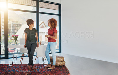 Buy stock photo Shot of two businesswomen chatting in an office