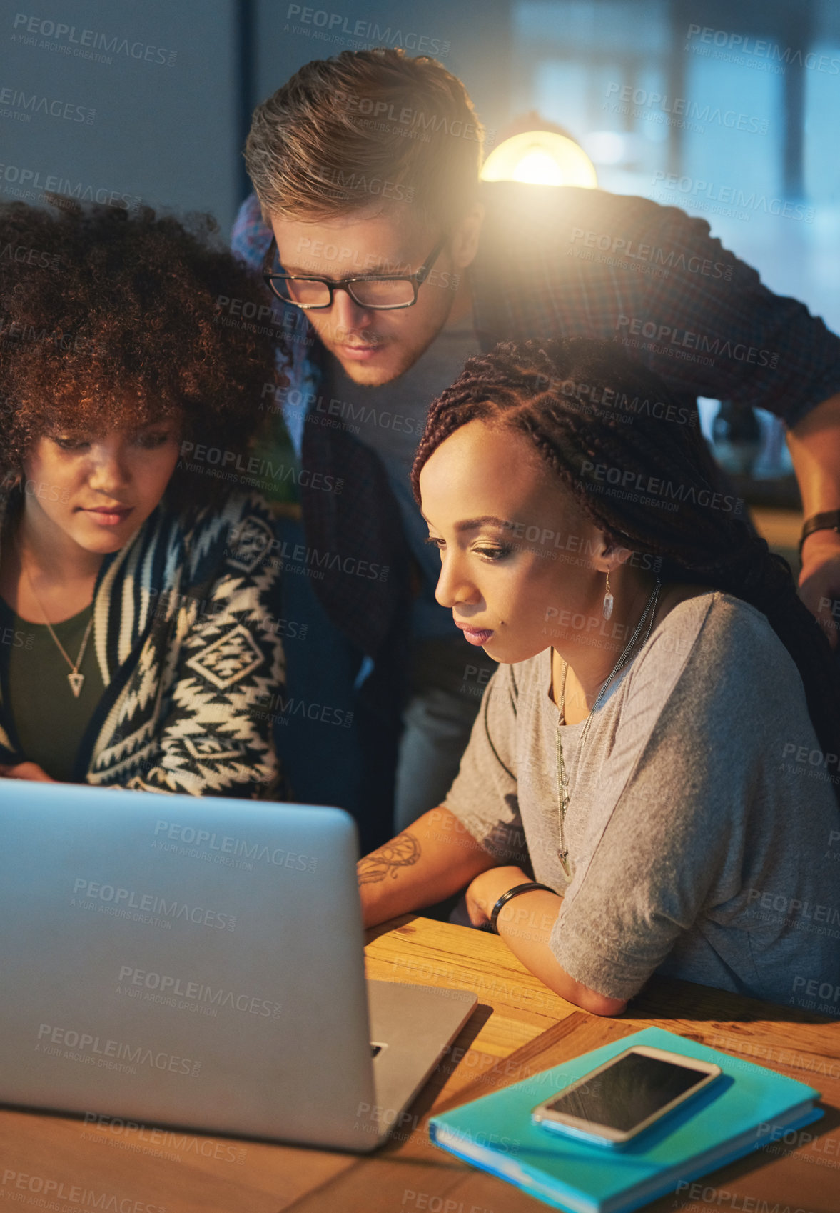 Buy stock photo Cropped shot of a group of young people working late in the office