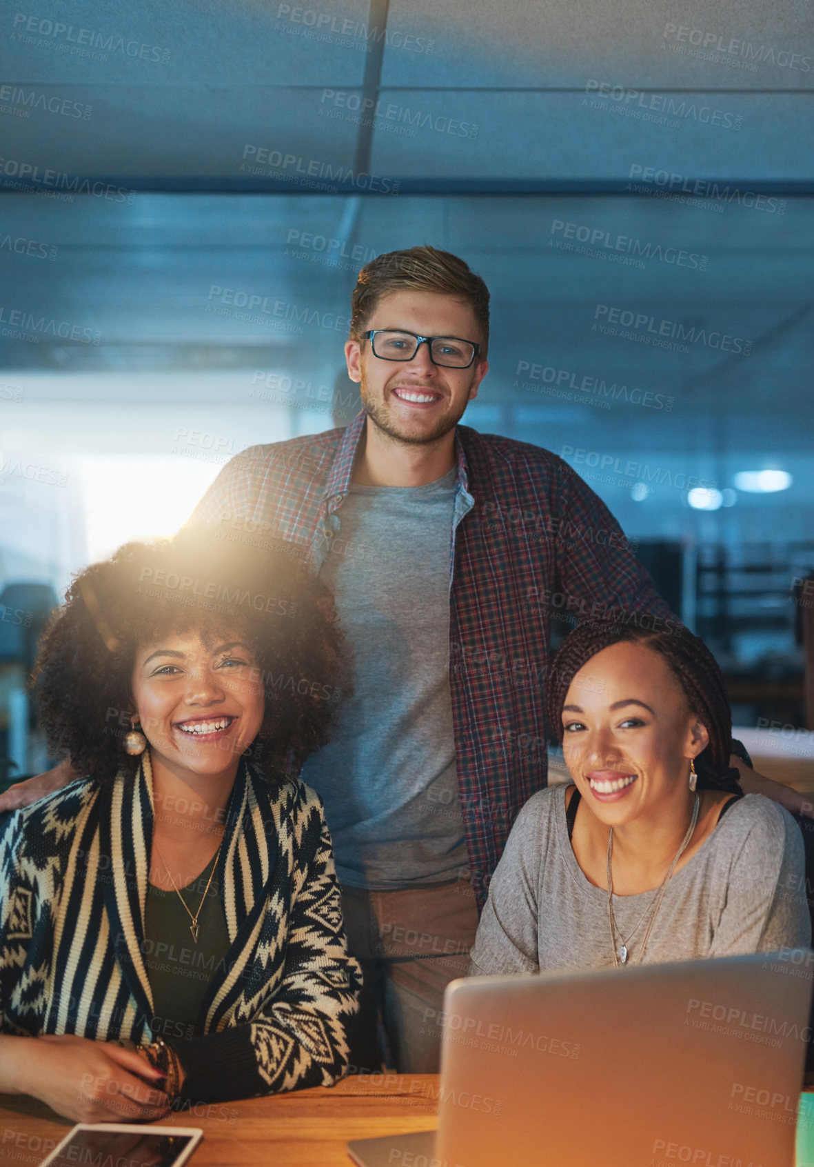 Buy stock photo Cropped portrait of a group of young people working late in the office
