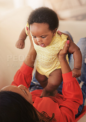 Buy stock photo Black family, mother and playing with baby in home, talking and love for growth or development. Lifting girl, connection and support infant daughter with bonding, motherhood and trust mommy.