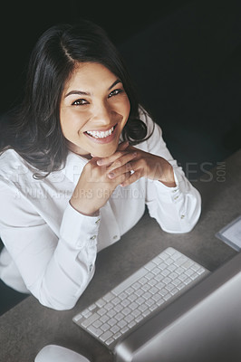 Buy stock photo High angle portrait of a young businesswoman working on a computer at work