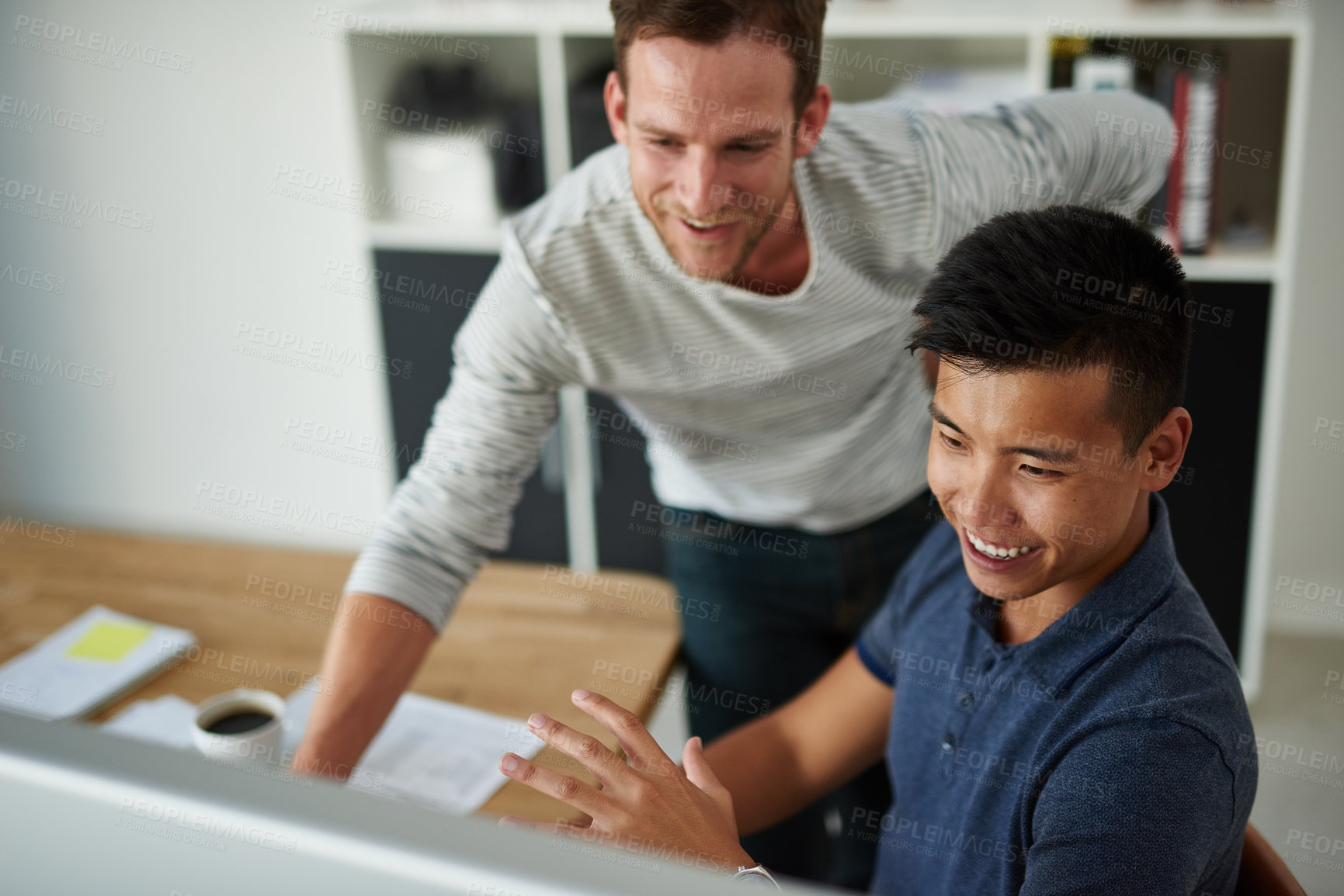 Buy stock photo High angle shot of two designers working together on a project in an office