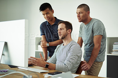Buy stock photo Cropped shot of three designers working together on a project in an office