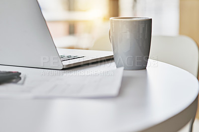 Buy stock photo Closeup shot of a laptop and coffee cup sitting on a desk