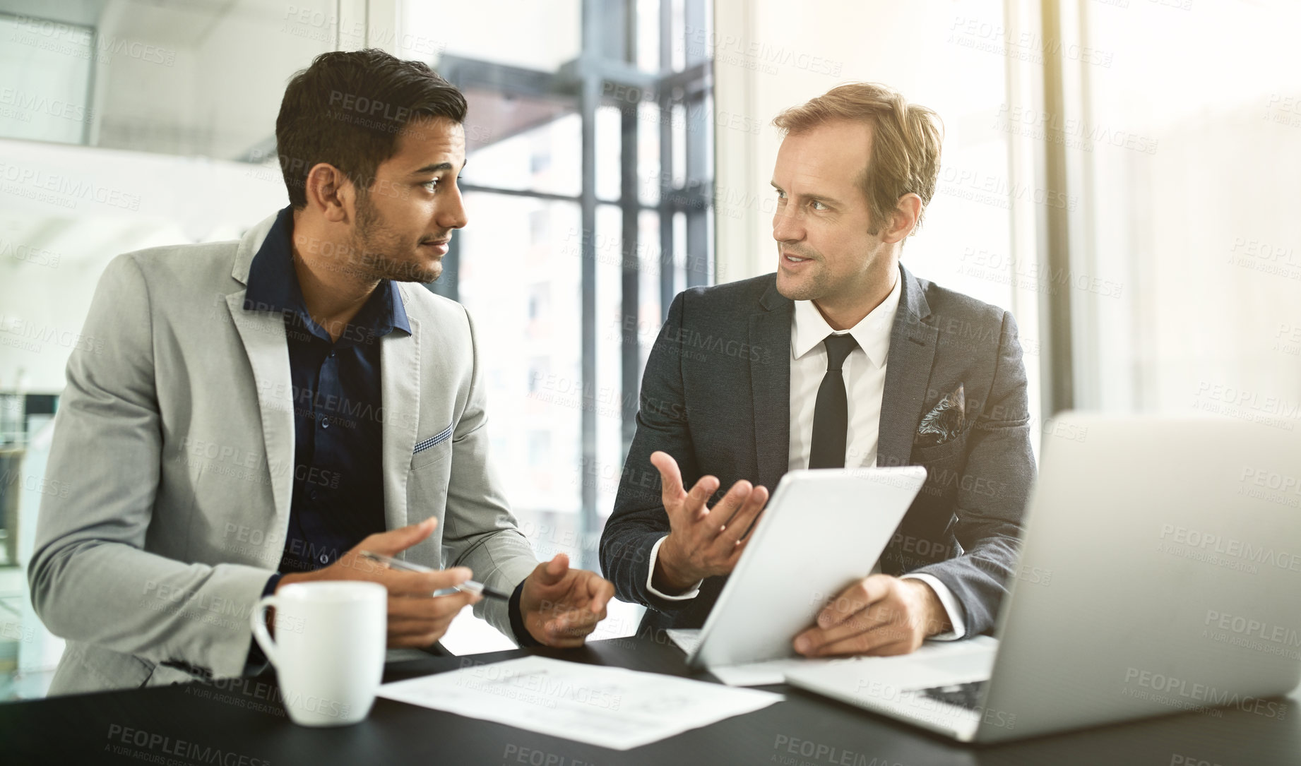 Buy stock photo Shot of two businesspeople having a discussion in an office