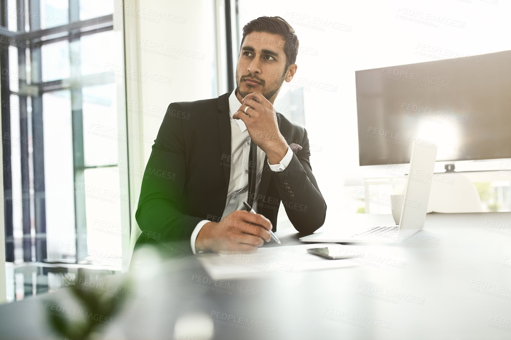 Buy stock photo Businessman, thinking and writing with laptop for proposal, ideas or company objectives at office. Young, man or employee in wonder, contemplating or thought for business decision, contract or policy