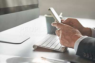 Buy stock photo Cropped shot of a businessman's hands using his cellphone in the office