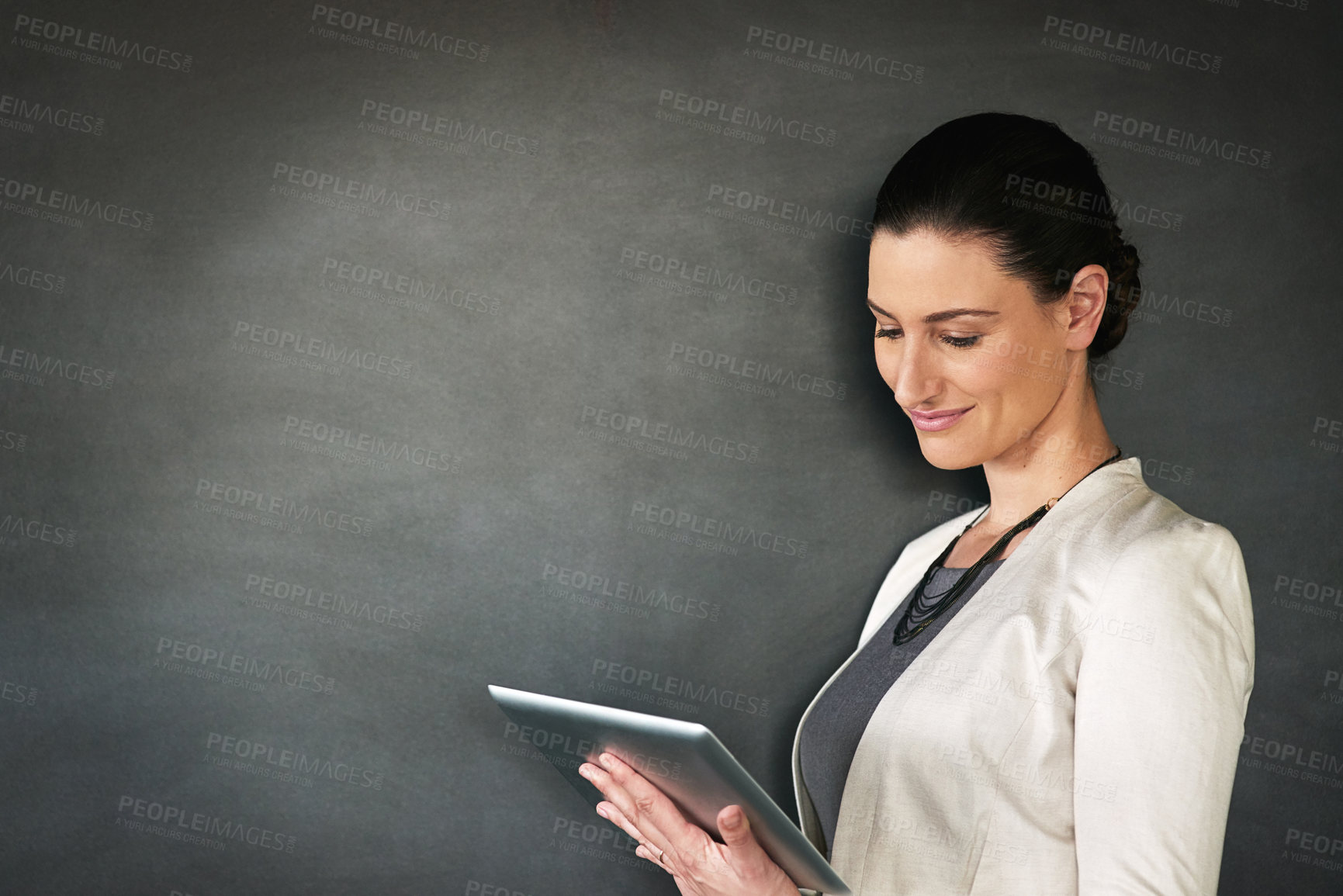 Buy stock photo Typing, teacher and woman in studio, tablet and confident person on gray background. Connection, model and educator with tech, mockup space and blackboard with digital application for lesson plan