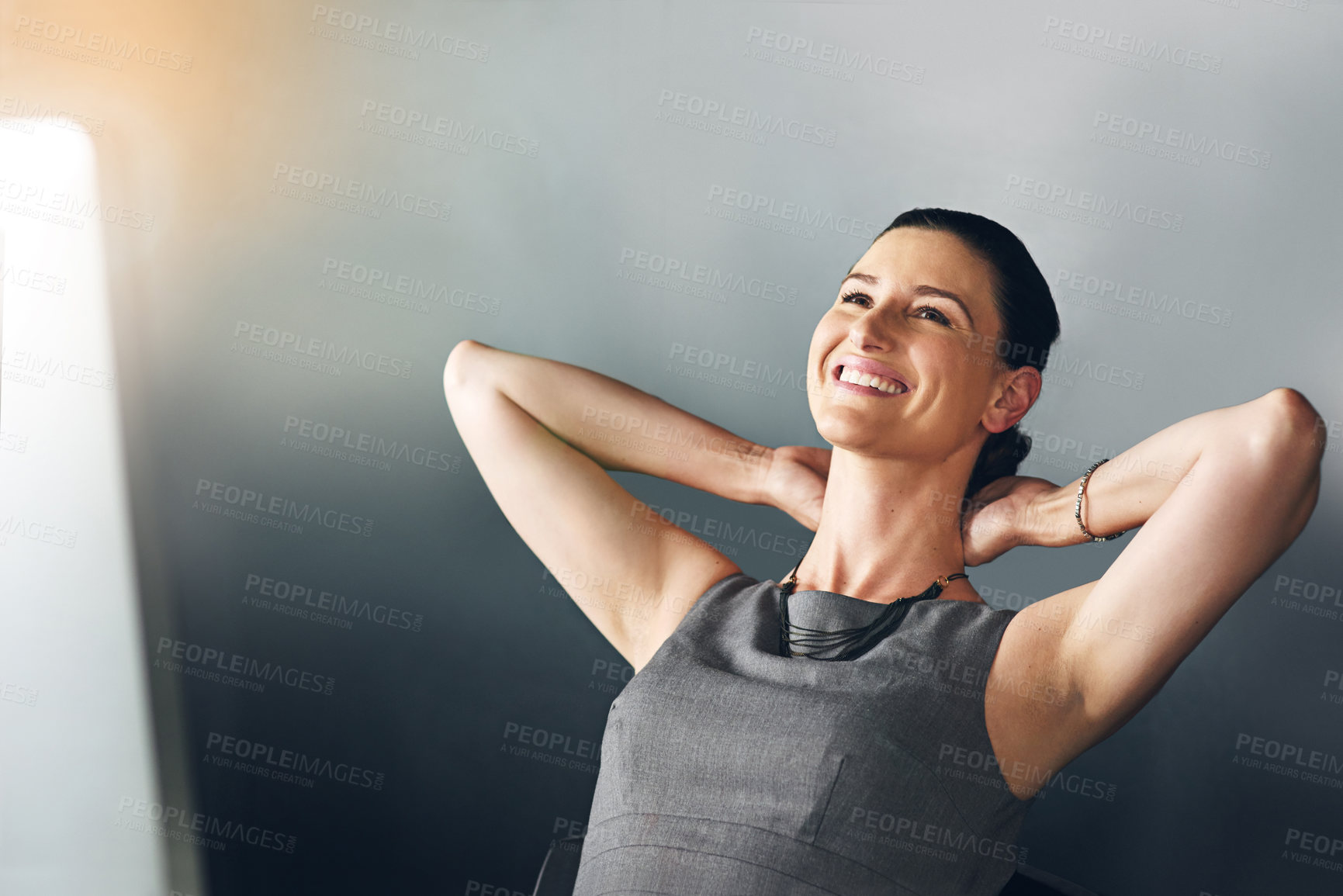 Buy stock photo Cropped shot of a businesswoman sitting with her hands behind her head in the office