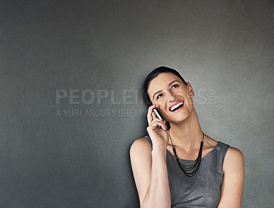 Buy stock photo Studio shot of a businesswoman using her cellphone against a grey background