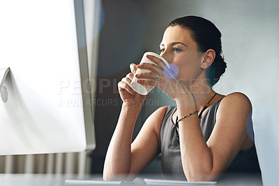 Buy stock photo Cropped shot of a businesswoman drinking coffee while sitting in her office