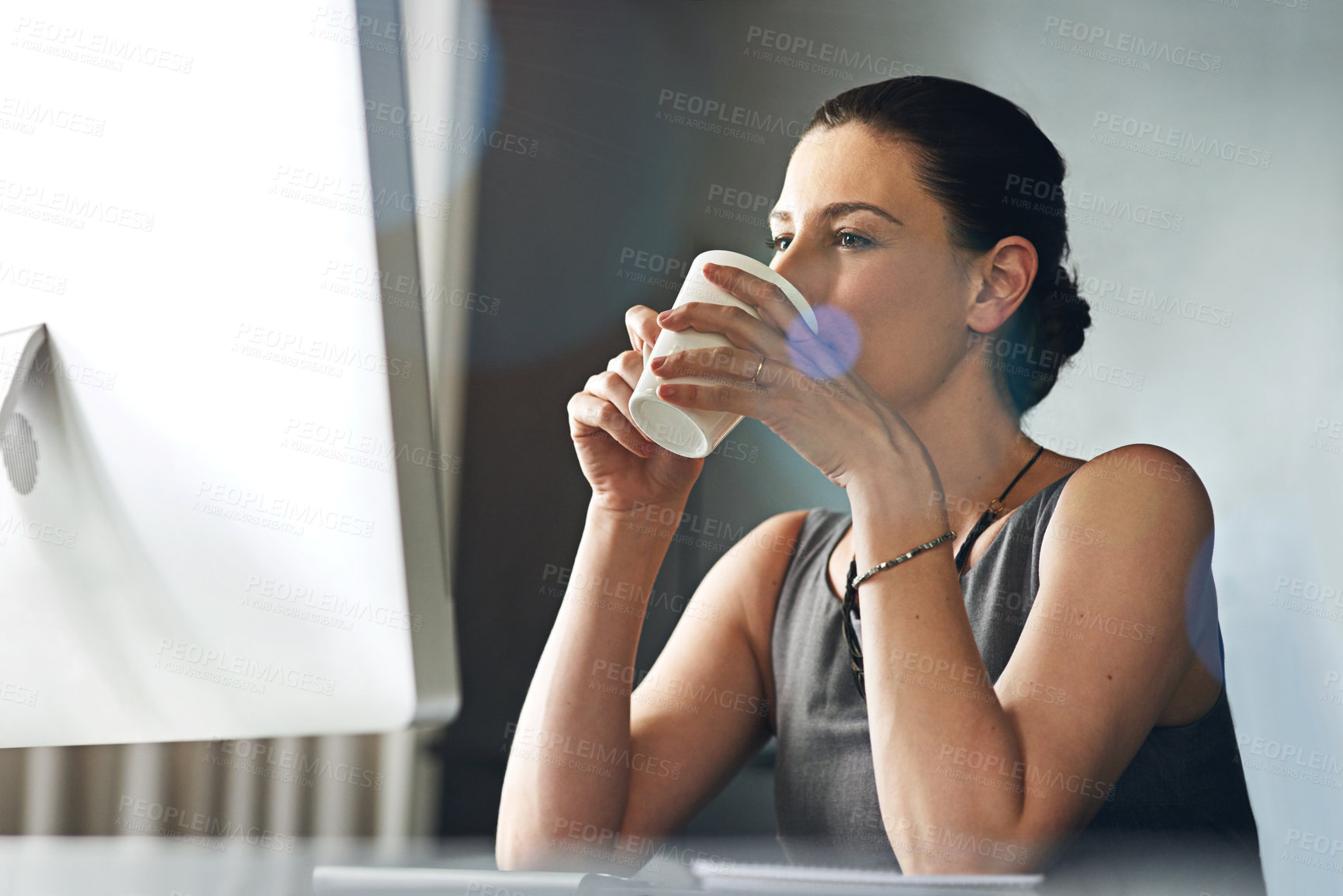 Buy stock photo Cropped shot of a businesswoman drinking coffee while sitting in her office