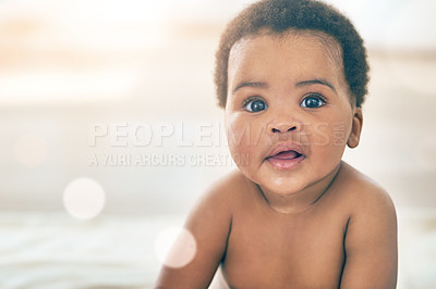 Buy stock photo Portrait, baby and mockup with an african child sitting on a bed in the bedroom of a home for growth or development. Children, face and an adorable black kid looking curious in a house with flare