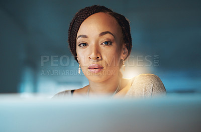 Buy stock photo Cropped portrait of a young woman using her laptop while working late in her office