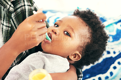Buy stock photo Shot of a mother feeding her little baby boy
