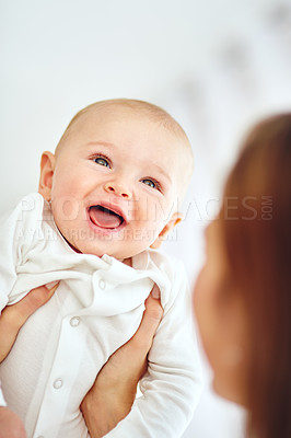 Buy stock photo Cute, little and happy baby in the arms of his mother or single parent. Innocent, pure and adorable newborn infant with his mom. Bonding together as a family with love, affection and happiness