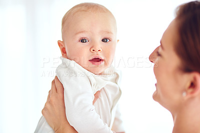 Buy stock photo Cute and innocent newborn baby boy bonding with his mom together as a family in studio isolated on a white background. Newborn male child in the hands of his single mother or parent with copyspace
