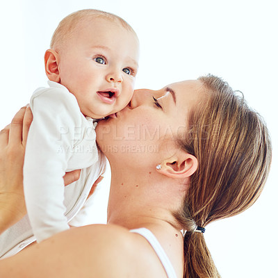 Buy stock photo Loving, caring and affectionate mother kissing and bonding with her baby. Female embracing motherhood holding her baby in the air enjoying a sweet moment of love, care and happiness 