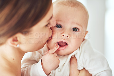 Buy stock photo Shot of a loving mother holding her baby boy at home