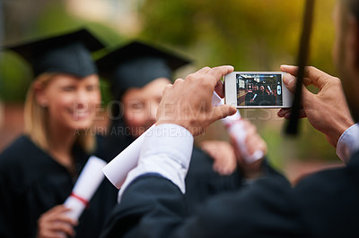 Buy stock photo Hands, phone and graduation photograph with students on campus together for ceremony or celebration. Mobile, photographer and screen with graduate friends at university or college for achievement