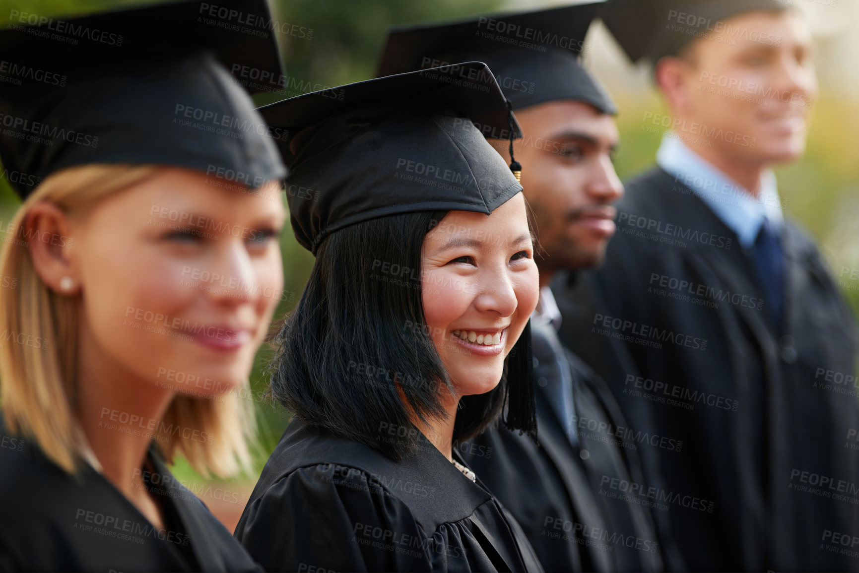 Buy stock photo Graduation, smile and woman student in row with friends for university or college ceremony outdoor. Education, scholarship and success with young person on campus for achievement or celebration