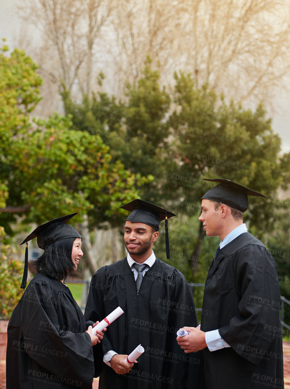 Buy stock photo Graduation, conversation and student friends on campus together for university or college education. Smile, happy or talking with group of graduate men and women outdoor at school for scholarship