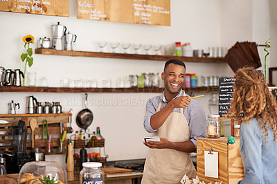 Buy stock photo Barista man, woman and happiness for order with smile, notes and service for good customer experience. Waiter, pen and lady with pointing, sale or special on menu in restaurant, cafe or coffee shop
