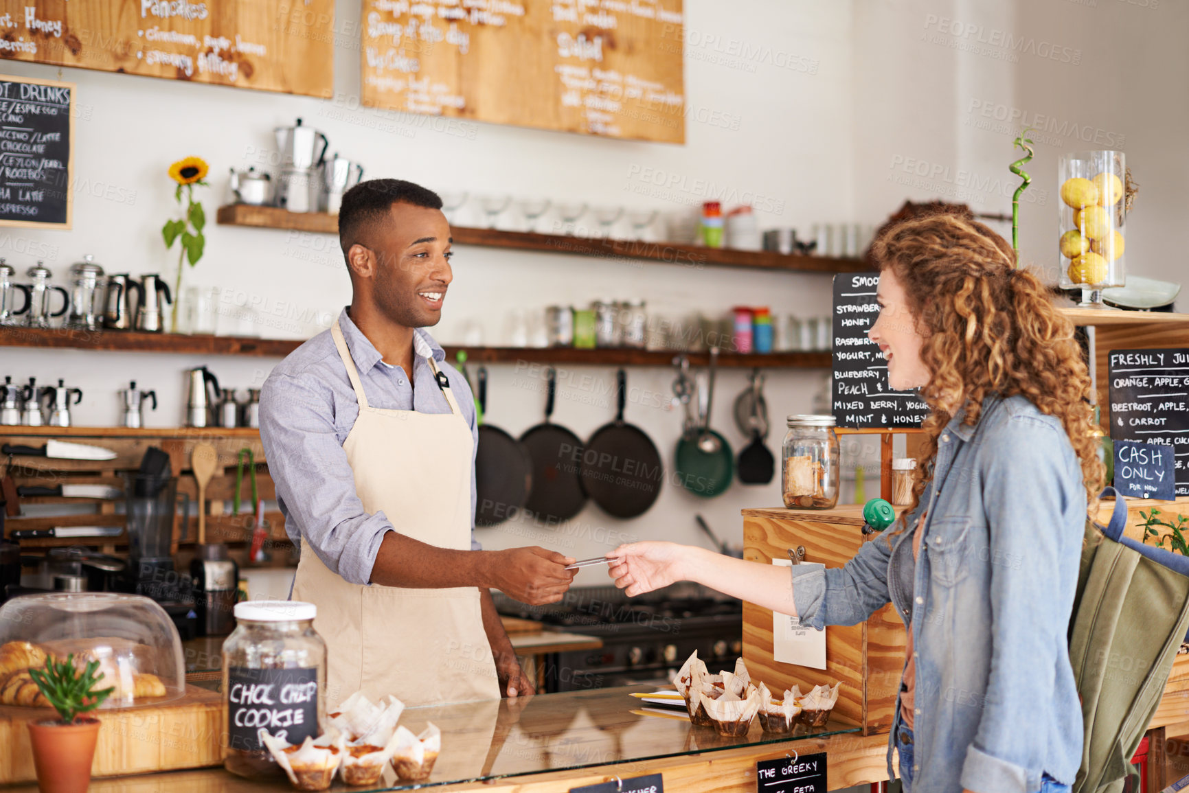 Buy stock photo Credit card, barista man and customer at a coffee shop with a payment and cafe worker. Restaurant, male service employee and female person paying for drink at checkout with waiter and smile in store