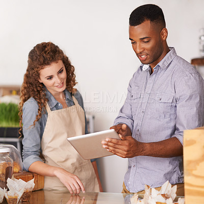 Buy stock photo Tablet, cafe owner and teamwork of people talking, discussion and manage orders. Waiters, black man and woman in restaurant with technology for inventory, stock check and managing sales in store.