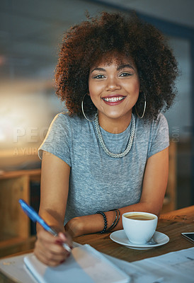 Buy stock photo Portrait of a young woman writing in a notebook during a late shift at the office