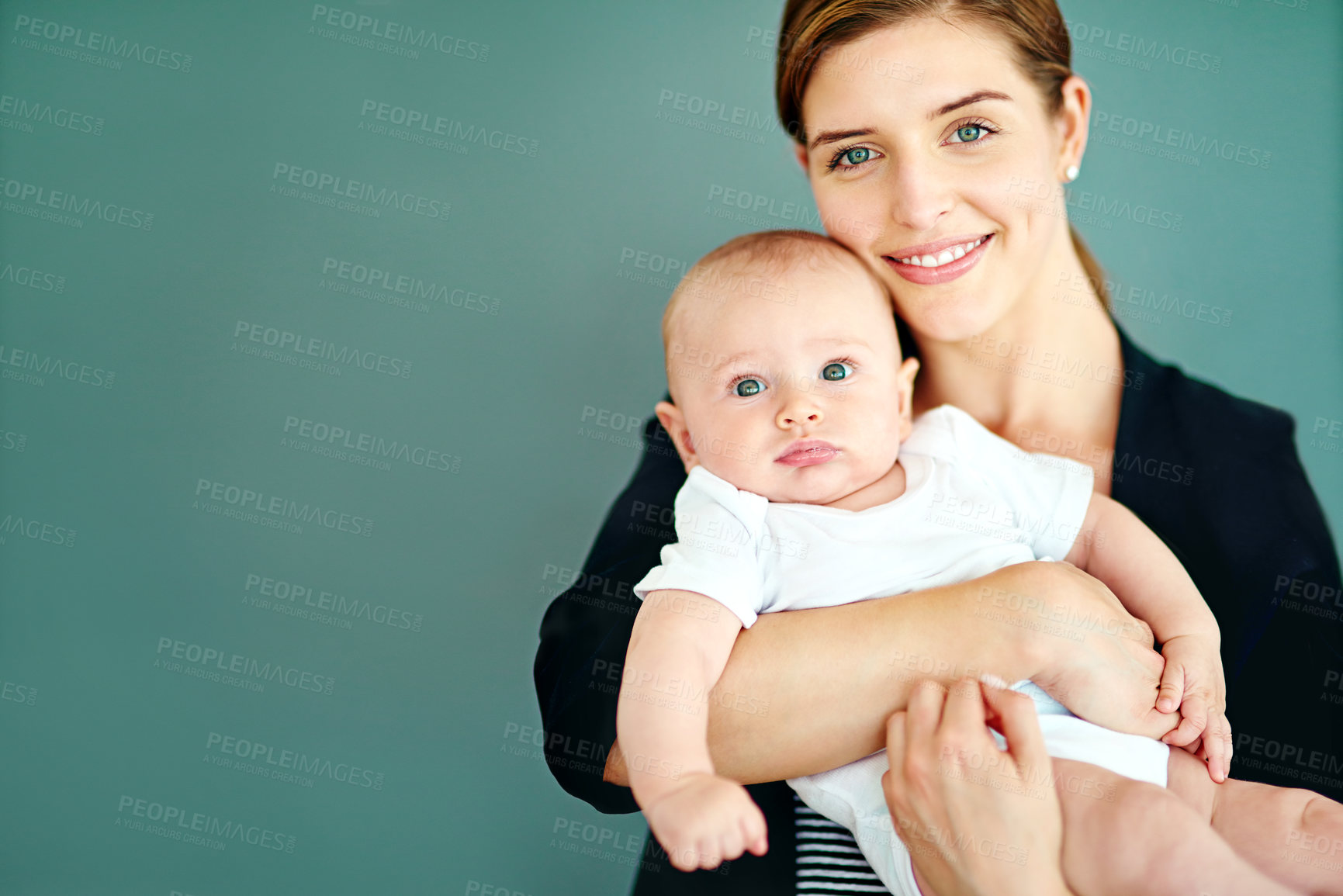 Buy stock photo Studio shot of a successful young businesswoman carrying her adorable baby boy