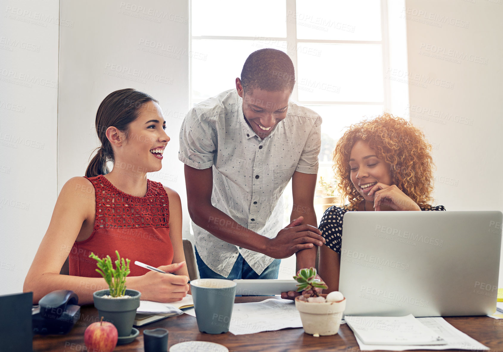 Buy stock photo Shot of a group of colleagues working together at a desk in an office