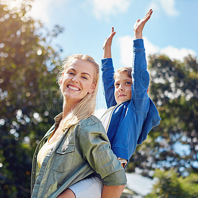 Buy stock photo Cropped portrait of a mother piggybacking her young son out in the woods