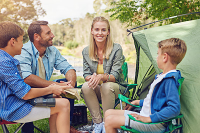 Buy stock photo Cropped shot of a family of four camping in the woods