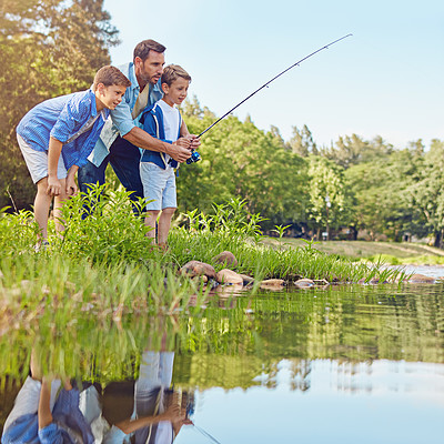 Buy stock photo Shot of a father and his two sons out fishing in the woods