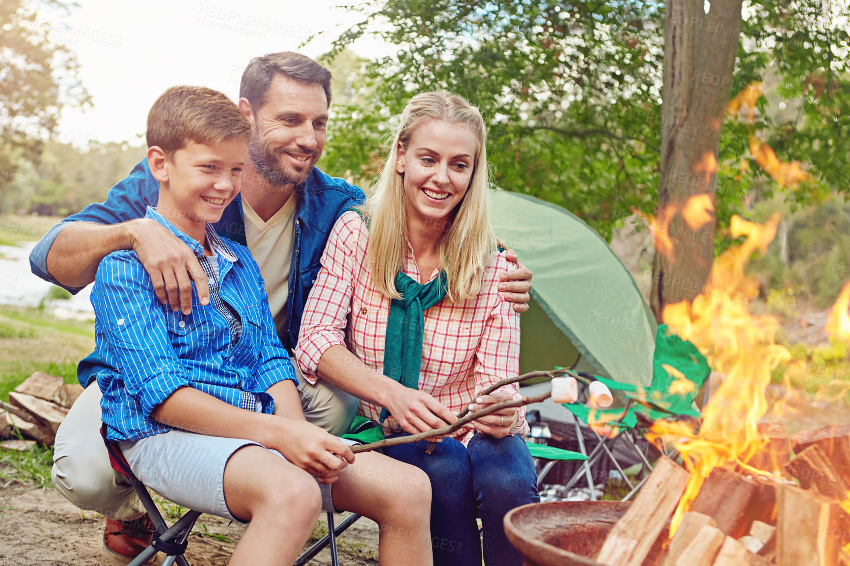 Buy stock photo Cropped shot of a family of three camping in the woods