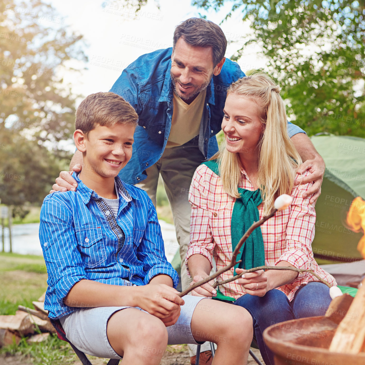 Buy stock photo Cropped shot of a family of three camping in the woods