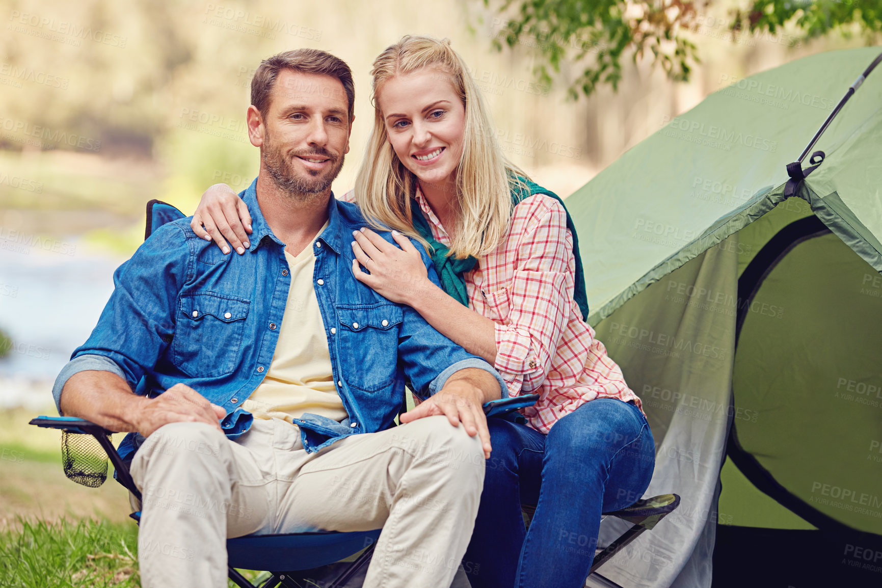 Buy stock photo Portrait of an affectionate couple camping out in the woods