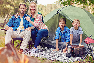 Buy stock photo Shot of a family of four camping in the woods
