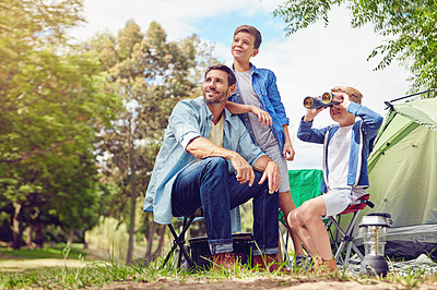 Buy stock photo Shot of a father and his two sons out camping in the woods