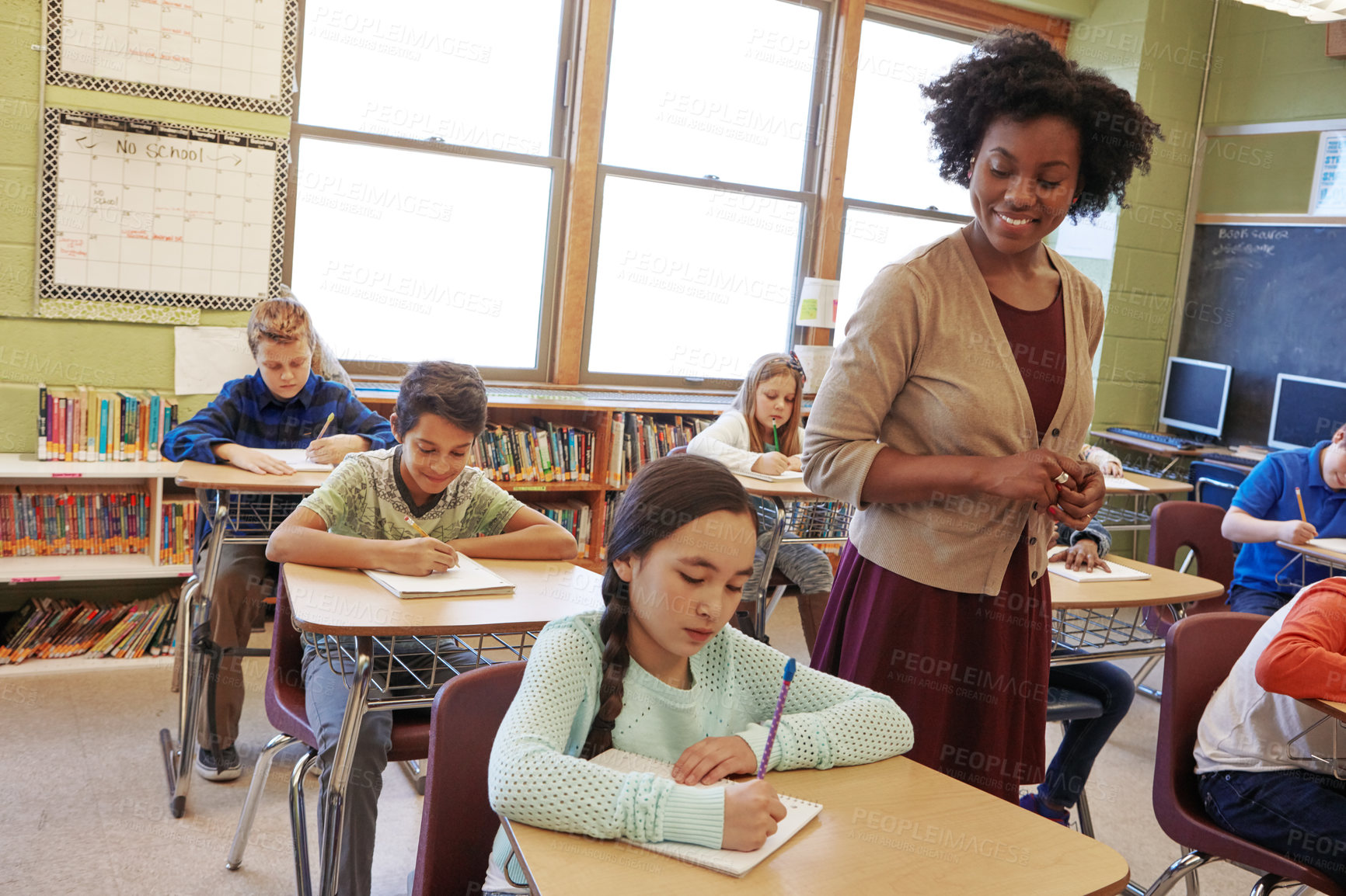 Buy stock photo Shot of a teacher in a classroom with her students