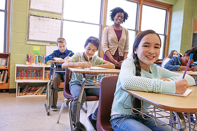 Buy stock photo Education, exam and portrait of a girl in class to study, writing and test at school. Happy, learning and student with a smile for studying in a classroom, notes and knowledge from a teacher