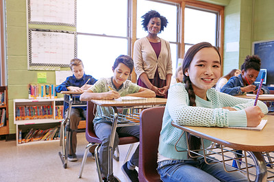 Buy stock photo Learning, teacher and portrait of a girl with a smile to study, writing and test at school. Happy, education and student at a desk for creativity in a classroom, studying notes and knowledge