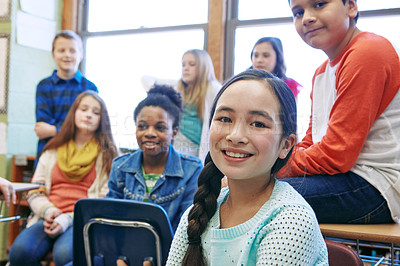 Buy stock photo Shot of a group of elementary school children sitting in a classroom