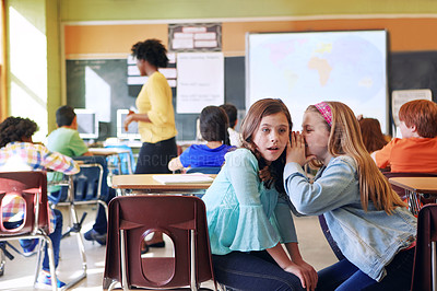 Buy stock photo School, friends and whispering in classroom for secret, gossip or chatting during teaching lesson. Sneaky female learners sharing quiet information secretly in ear at class while teacher is busy