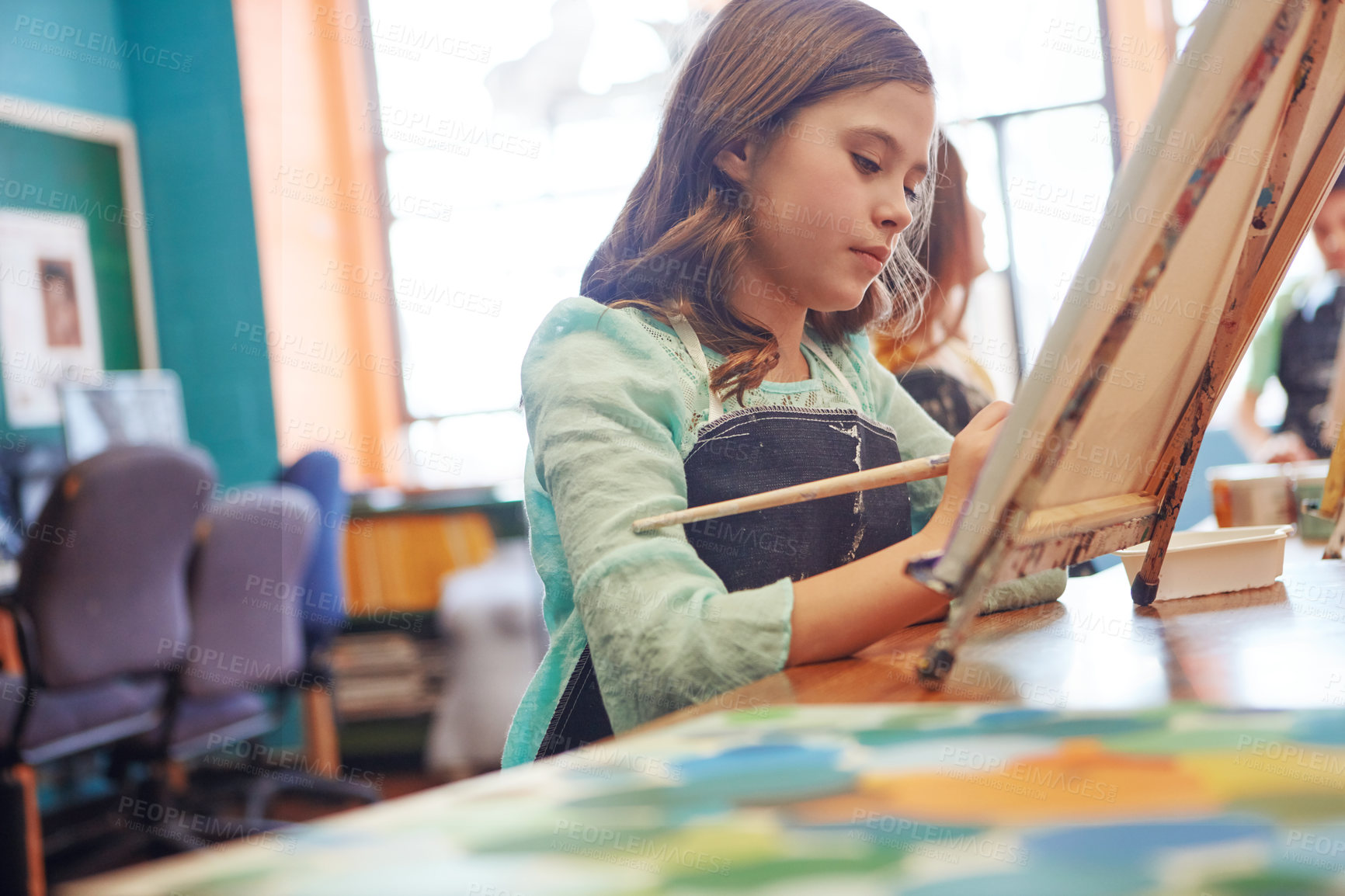 Buy stock photo Shot of a young schoolgirl in an art class