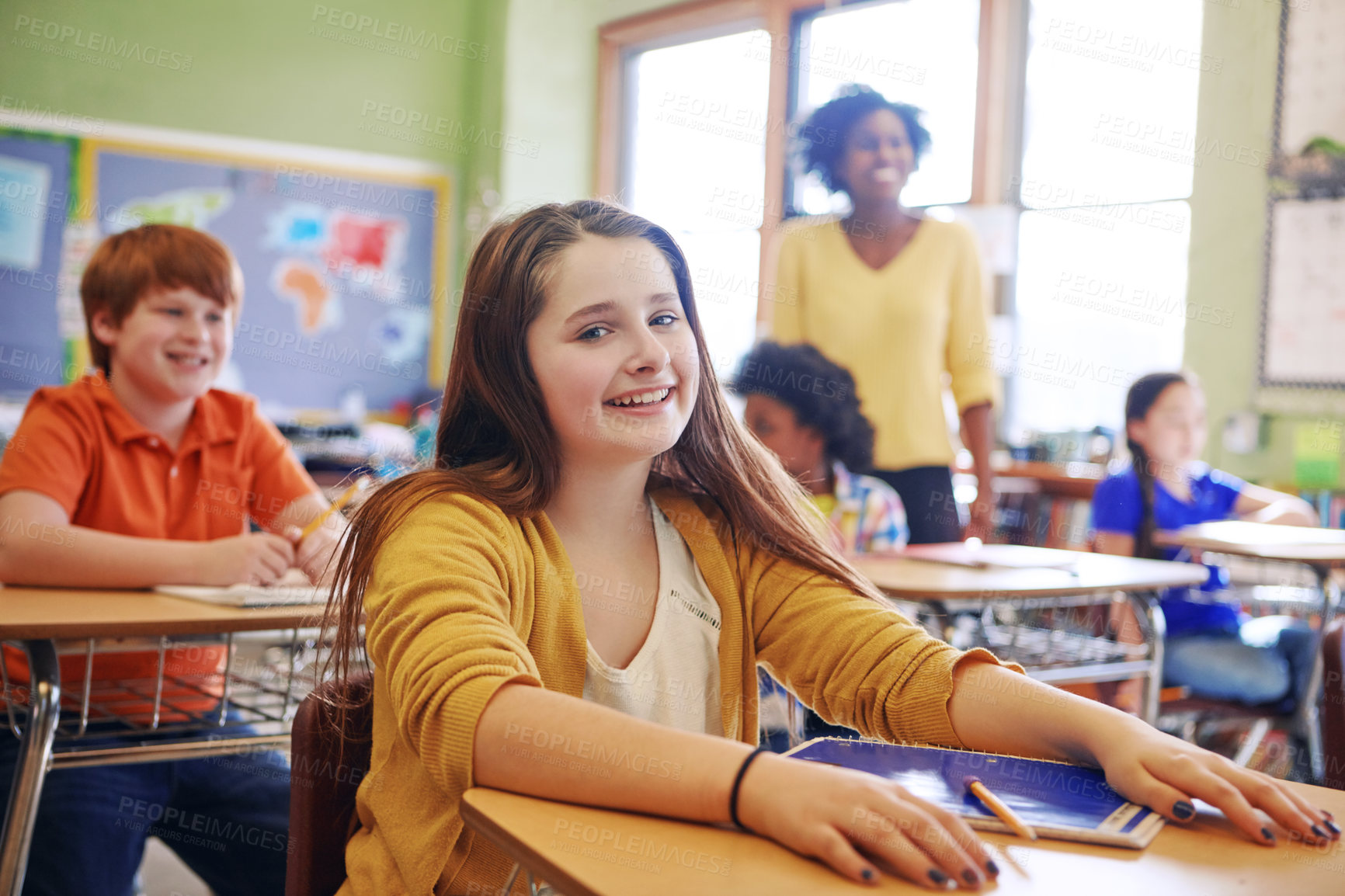 Buy stock photo Portrait of a young schoolgirl sitting at her desk in class