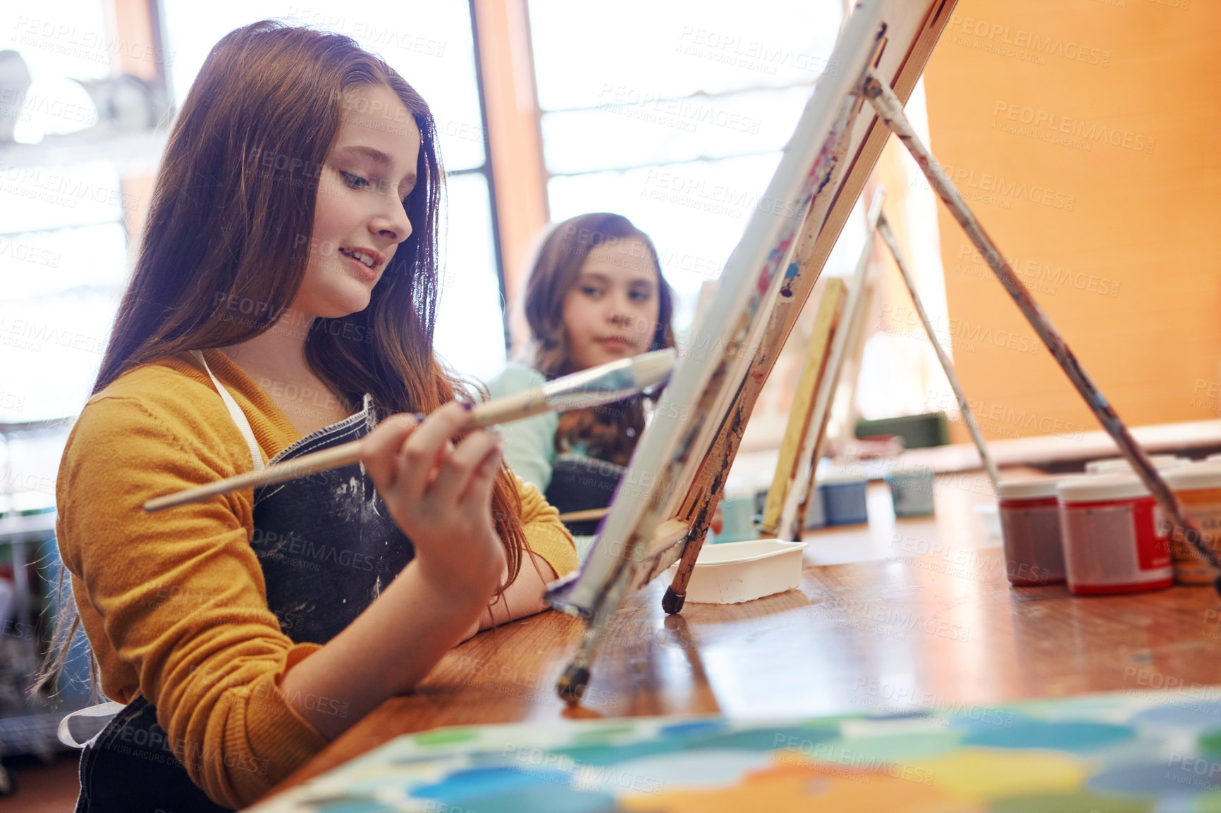 Buy stock photo Shot of a young schoolgirl in an art class