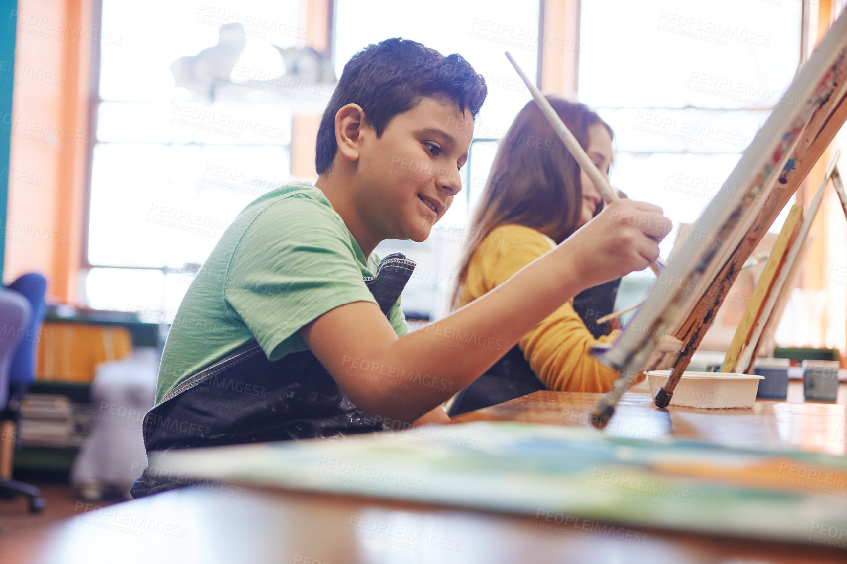 Buy stock photo Shot of a young schoolboy in an art class