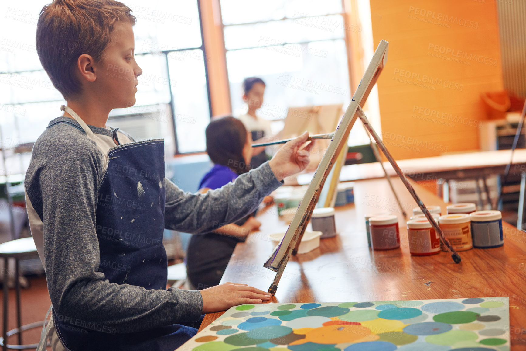 Buy stock photo Shot of a young schoolboy in an art class